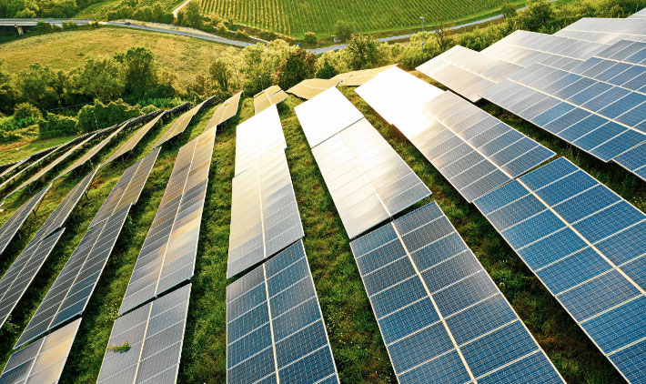 Solar park on green hill with many solar panels 