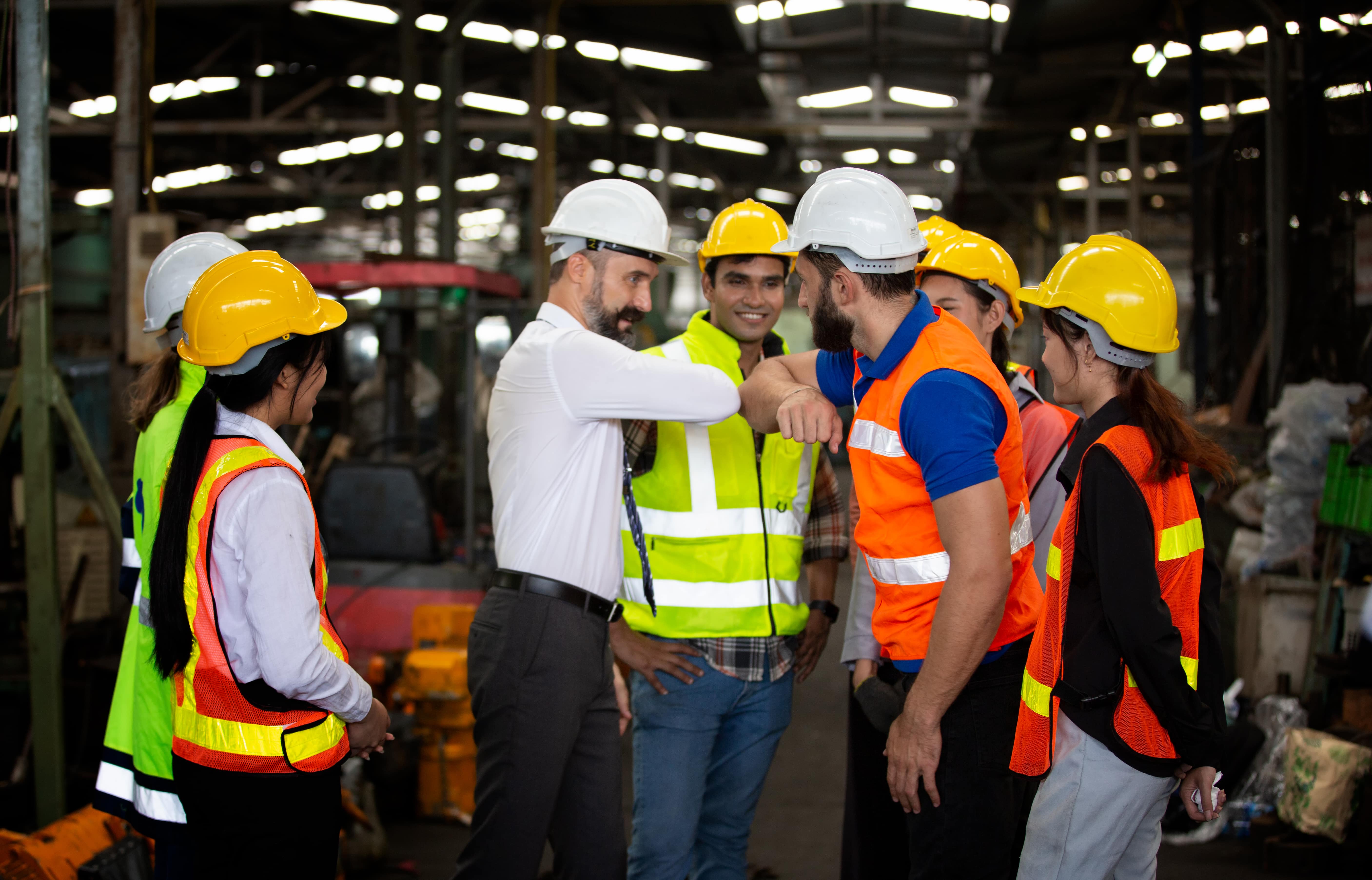 Group of workers standing against production line